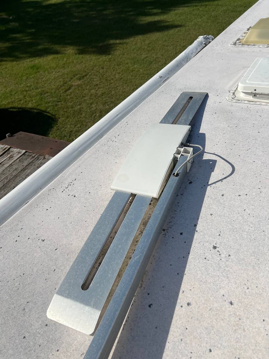 After: the same roof, membrane bright and clean, antenna and rails free of grime