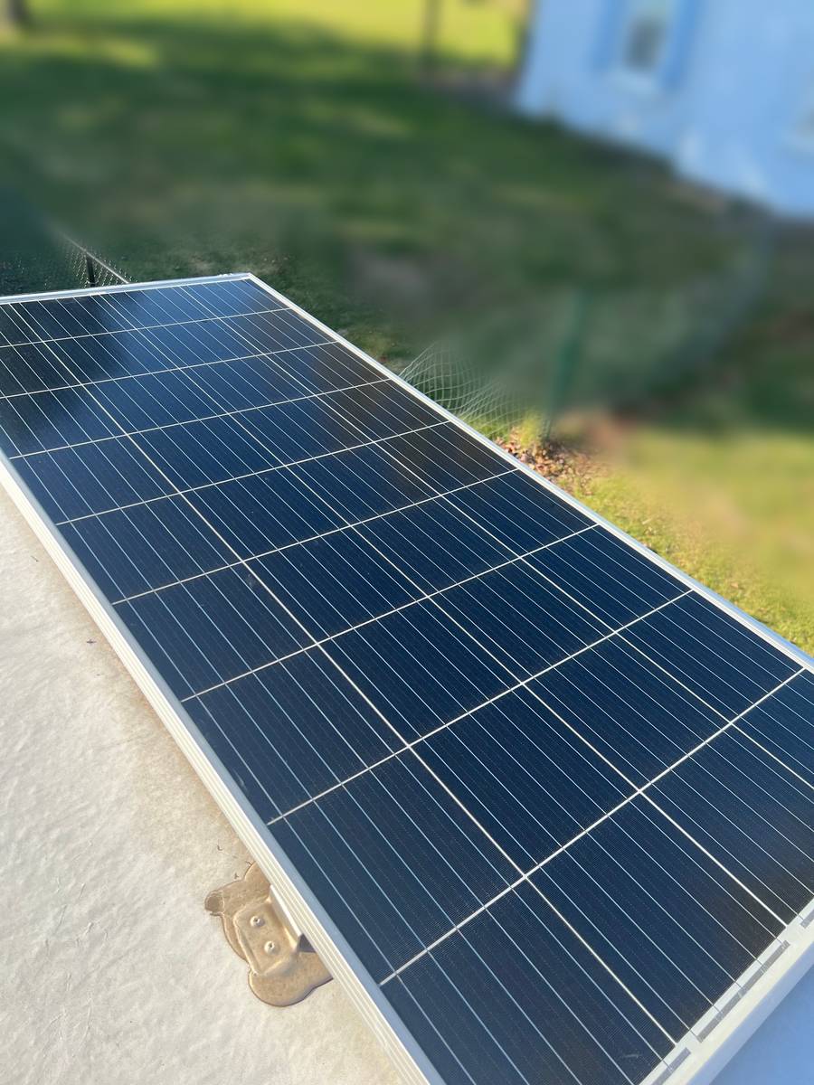 After: the same solar panel with a clean, clear surface, and the roof around its mount brighter